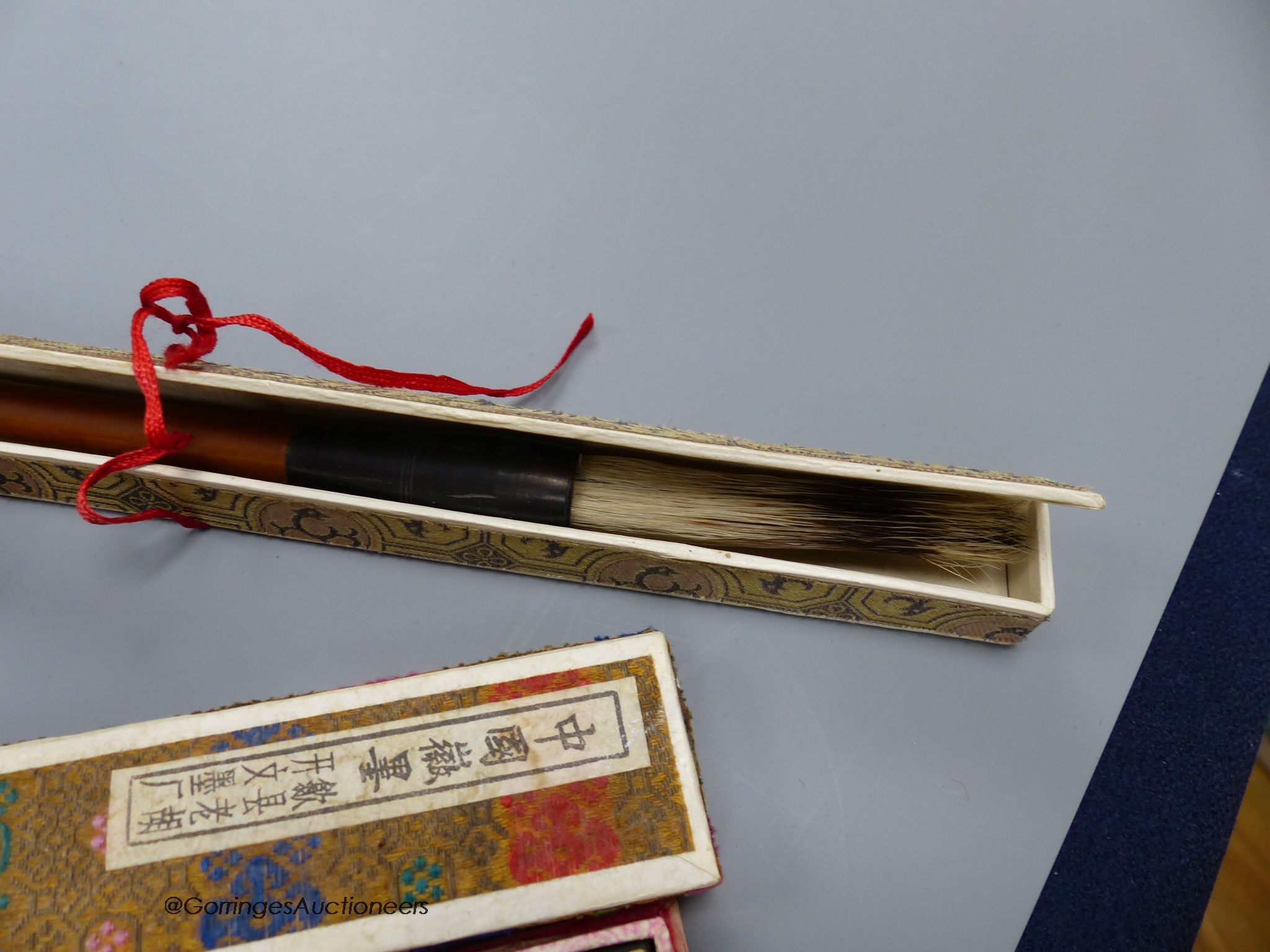 A Chinese inkstone and other calligraphy related items